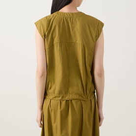 Model wearing Transit olive cotton shirt, back view, with matching olive drawstring trousers
