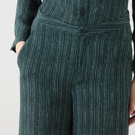 Model wearing Transit Stripe Wide Leg Trousers in petrol, showing wide-cut silhouette, vertical stripe pattern and side pocket detail.