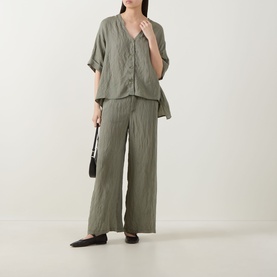 Model wearing Transit Textured Wide Leg Trousers in green, styled with matching green shirt, small black bag and dark flat shoes.