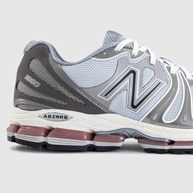 New Balance 1906R trainer in dark silver metallic grey, featuring mesh upper, N logo branding, ABZORB midsole, and mauve outsole detail.