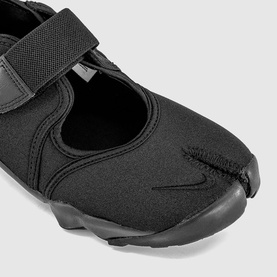 Nike split-toe shoe in black with velcro strap, stretch neoprene upper and black rubber sole, close-up detail view.