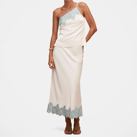 Model wearing Forever New champagne midi skirt with blue lace hem trim, styled with matching lace camisole top and brown sandals.