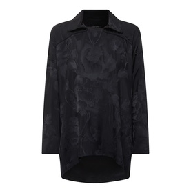 Annette Gortz black viscose blouse with tonal floral jacquard pattern, spread collar, long sleeves, and dipped hem.