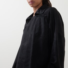 Model wearing Annette Gortz black viscose blouse, close-up showing relaxed collar and oversized silhouette