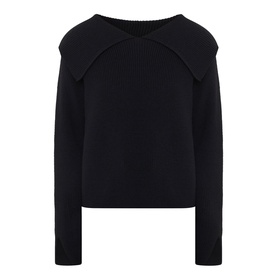 Annette Gortz black merino wool knit top with wide fold-over collar and long sleeves, flat lay