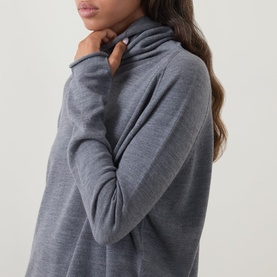 Model wearing Annette Gortz melange merino wool turtleneck top, close-up detail of draped neckline and long sleeve cuff