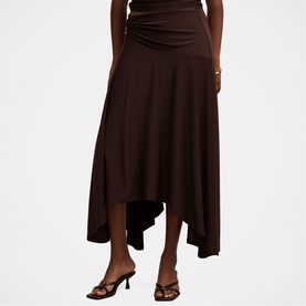 Model wearing Forever New Dark Chocolate asymmetric midi skirt with ruched waistband, styled with strappy heeled sandals
