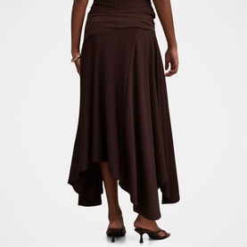 Model wearing Forever New Dark Chocolate asymmetric midi skirt with draped waistband, styled with strappy heeled mules.
