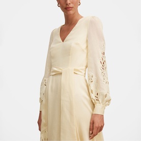 Model wearing Forever New soft yellow midi dress with V-neckline, broderie anglaise sleeves, and bow waist detail