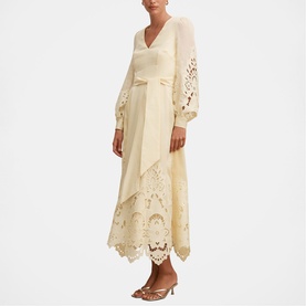 Model wearing Forever New soft yellow midi dress with lace cutwork hem, balloon sleeves, and wrap-style bodice, styled with nude heels.