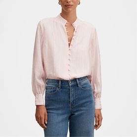 Model wearing Forever New blush pink ruffle-neck button-front blouse with blouson sleeves, styled with blue jeans