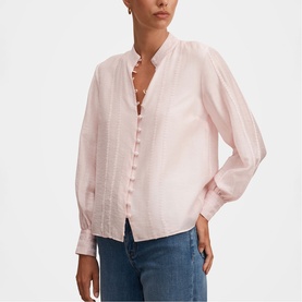 Model wearing Forever New blush pink textured button-front blouse with ruffle collar and blouson sleeves, styled with blue jeans