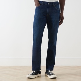 Model wearing Citizens of Humanity 3049 Straight Jeans in dark indigo, styled with black low-top trainers