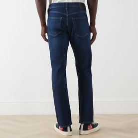 Model wearing Citizens of Humanity 3049 Straight Jeans in dark indigo, rear view showing classic five-pocket styling and straight leg fit.