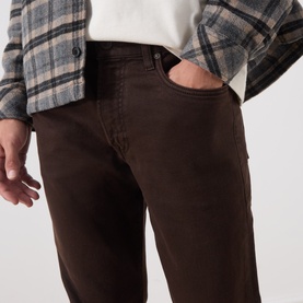 Model wearing Citizens of Humanity Straight Jeans in Tobacco, styled with a white tee and plaid overshirt