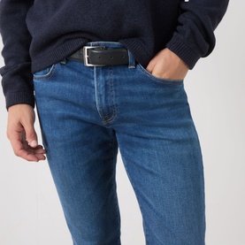 Model wearing Citizens of Humanity Gage Slim Leg Jeans in Watson mid wash, styled with a navy jumper and black leather belt.