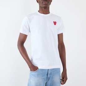Model wearing Comme Des Gar&ccedil;ons Play Double Heart Embroidered Logo T-Shirt in white, styled with light blue jeans.