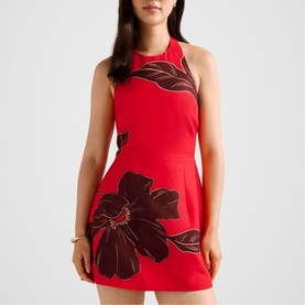 Model wearing Forever New red mini dress with halterneck and oversized dark floral print, sleeveless fit