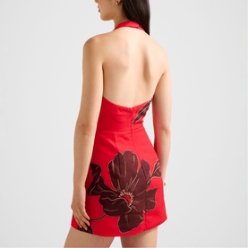Model wearing Forever New red halterneck mini dress with open back and large dark floral print, shown from rear angle