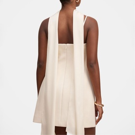 Model wearing Forever New Cannoli Cream sleeveless mini dress, rear view showing draped back panel detail and zip fastening.