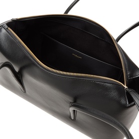 DeMellier Stockholm Shoulder Bag in black grained leather, open top zip showing interior, gold-tone hardware detail visible