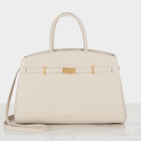 DeMellier The Hudson Midi Top Handle Bag in chalk grained leather, gold-plated hardware, signature belted strap and detachable crossbody strap