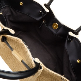 DeMellier The New York Midi Top Handle Bag in warm raffia and black, interior view showing black leather lining and gold-plated magnetic closure