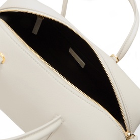 DeMellier The Stockholm Midi Top Handle Bag in Chalk, showing black interior lining, gold-tone zip hardware and grained leather exterior detail.