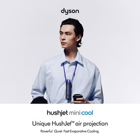 Model with Dyson HushJet Mini Cool Fan in Ink/Cobalt worn around neck, paired with light blue shirt and bag