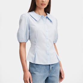 Model wearing Forever New soft blue puff-sleeve blouse with oversized collar and button-front, styled with light wash jeans