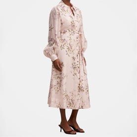Model wearing blush pink floral print midi shirt dress with long sleeves and tie waist, styled with black heeled mules