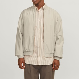Model wearing Jack & Jones Moonbeam Casual Jacket over striped shirt with taupe trousers