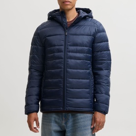 Model wearing Jack & Jones Kingsley Light Hooded Puffer Jacket in Navy Blazer, styled with blue jeans. Zip fastening, elasticated cuffs visible.