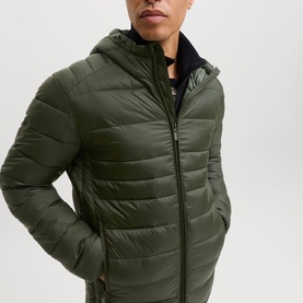 Model wearing Jack & Jones Kingsley Light Hooded Puffer Jacket in Rosin, zip fastening, front zip pockets, styled with dark crew-neck top.