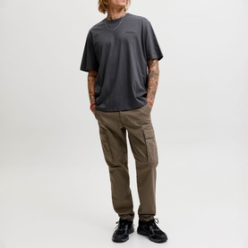 Model wearing Jack & Jones Archive Graphic Logo T-Shirt in Asphalt, styled with khaki cargo trousers and black trainers.