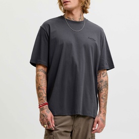 Model wearing Jack & Jones Archive Graphic Logo T-Shirt in Asphalt, crew neck, short sleeves, with khaki cargo trousers and silver chain necklace.