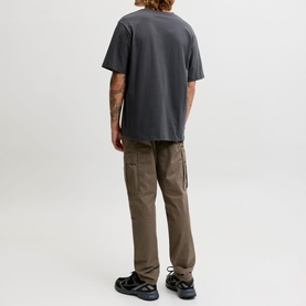 Model wearing Jack & Jones Archive Graphic Logo T-Shirt in Asphalt, styled with khaki cargo trousers and black trainers, rear view.