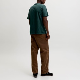 Model wearing Jack & Jones Soho Logo T-Shirt in Scarab green, short sleeves, styled with brown trousers and black shoes, rear view.