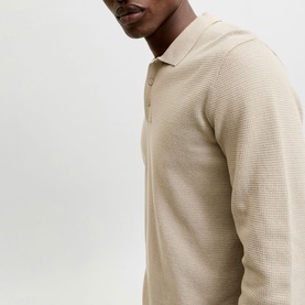 Model wearing a stone textured knit long-sleeve polo shirt with open collar and button placket