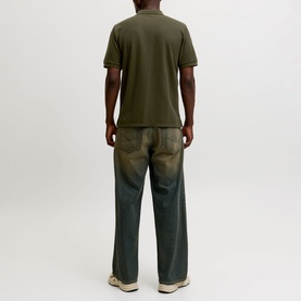 Model wearing Jack & Jones Austin Logo Polo Shirt in Rosin, back view, paired with olive wide-leg trousers.