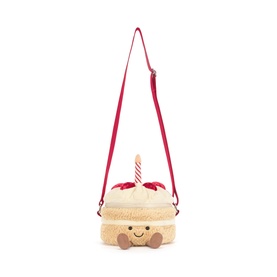 Jellycat Amuseables Birthday Cake Bag in cream plush with pink crossbody strap, smiley face, candle and berry detail