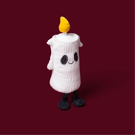 Jellycat Amuseables white plush candle soft toy with smiling face, yellow flame top, and small black feet