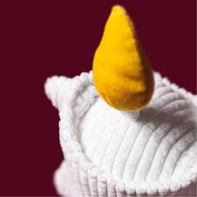 Jellycat Amuseeable white plush candle soft toy, close-up showing ribbed texture and yellow felt flame detail