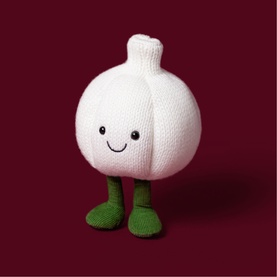 Jellycat Amuseables white knitted garlic plush toy with smiling face and green feet, medium size