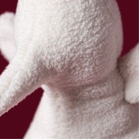 Jellycat white plush soft toy close-up showing fluffy textured fabric detail on ear and body