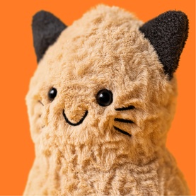 Jellycat Amuseables plush cat soft toy in tan and black, with textured fur, embroidered whiskers and bead eyes, close-up detail shot