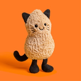 Jellycat Amuseables plush cat toy in cream textured body with black ears, paws and tail, on orange background