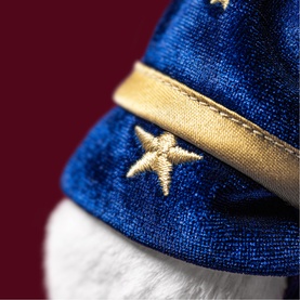 Jellycat plush toy detail showing blue velvet fabric with gold embroidered stars and gold trim band
