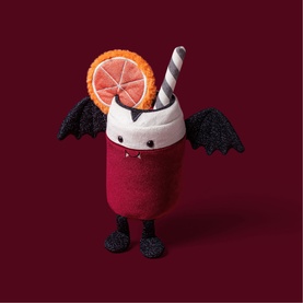 Jellycat Amuseables plush devil smoothie toy with bat wings, orange slice, straw, and tiny horns, in red and white multi colourway