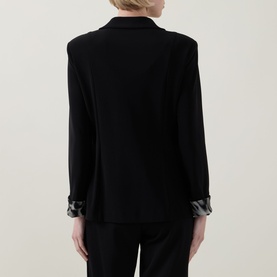 Model wearing Joseph Ribkoff black blazer, rear view, with contrast cuff lining detail and tailored fit, styled with black trousers.